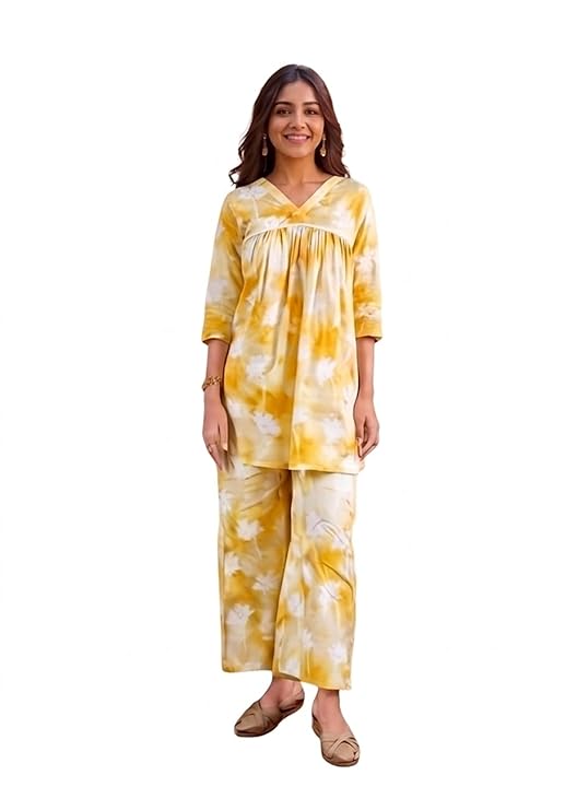 Woman wearing a yellow printed co ord set with wide-leg pants and three-quarter sleeves.