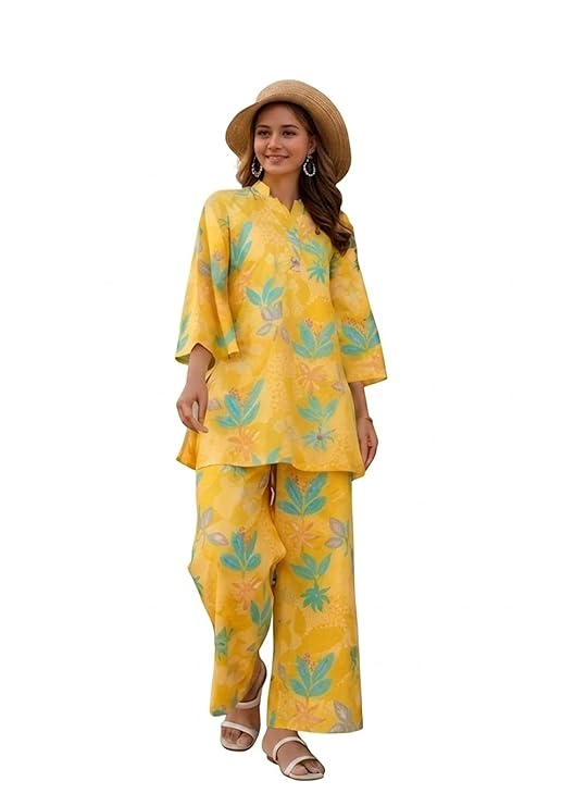 Woman wearing a yellow floral printed co ord set with matching pants and a summer hat.
